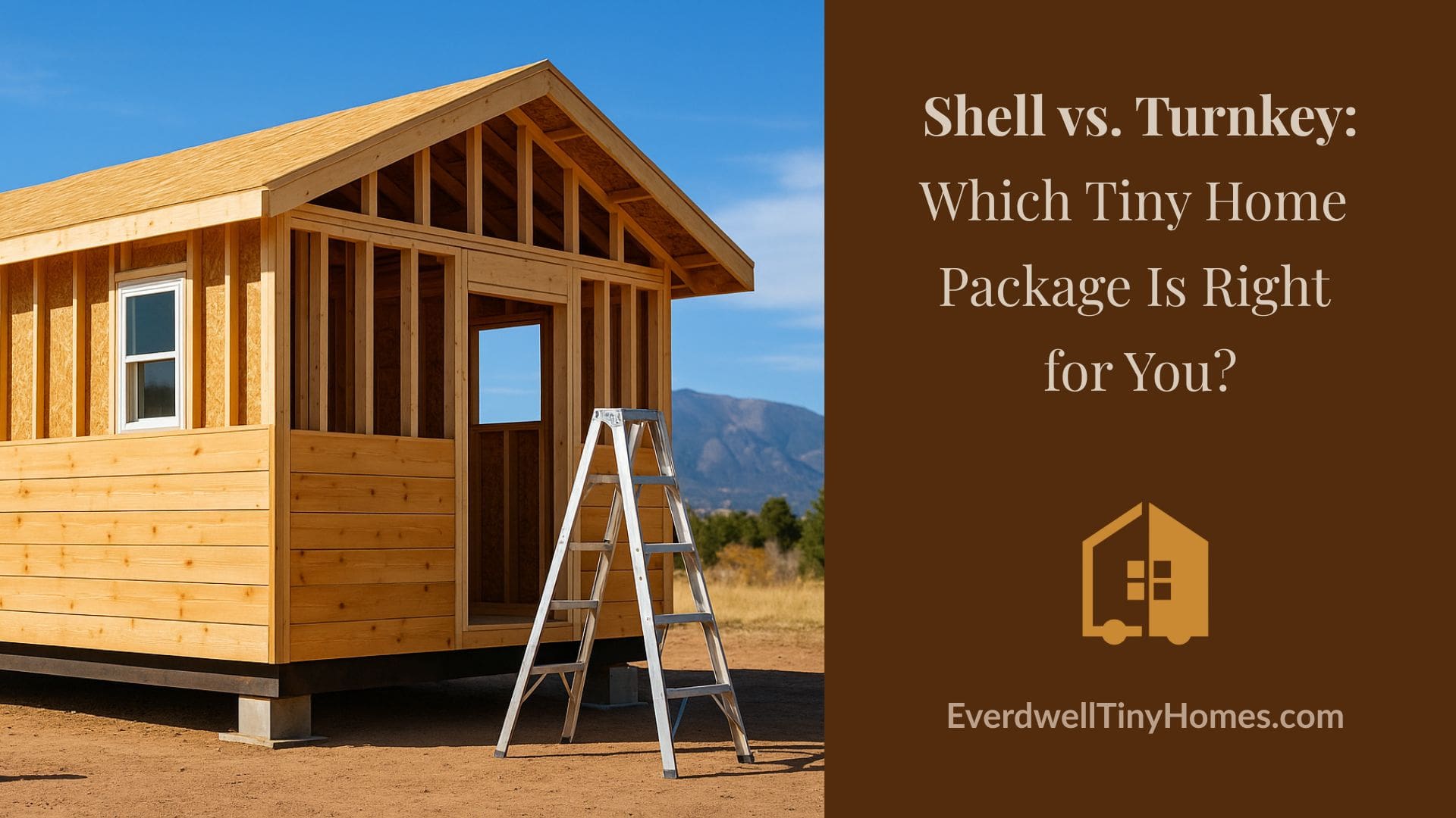 EverDwell Shell Package tiny home under construction in Colorado Springs, featuring completed framing and wood siding with the Rocky Mountains in the background under a clear blue sky.